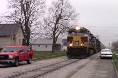 Pociąg przejeżdżający drogą przez środek osiedla 